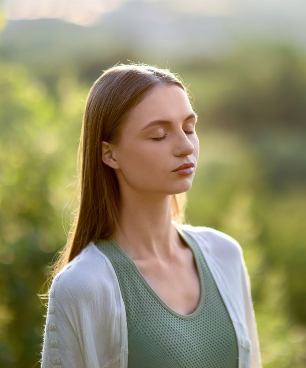 Woman with eyes closed, calm in the sunlight